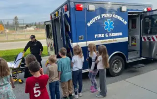 Firefighter and EMT David Stehlar talks to second graders about the ambulance.